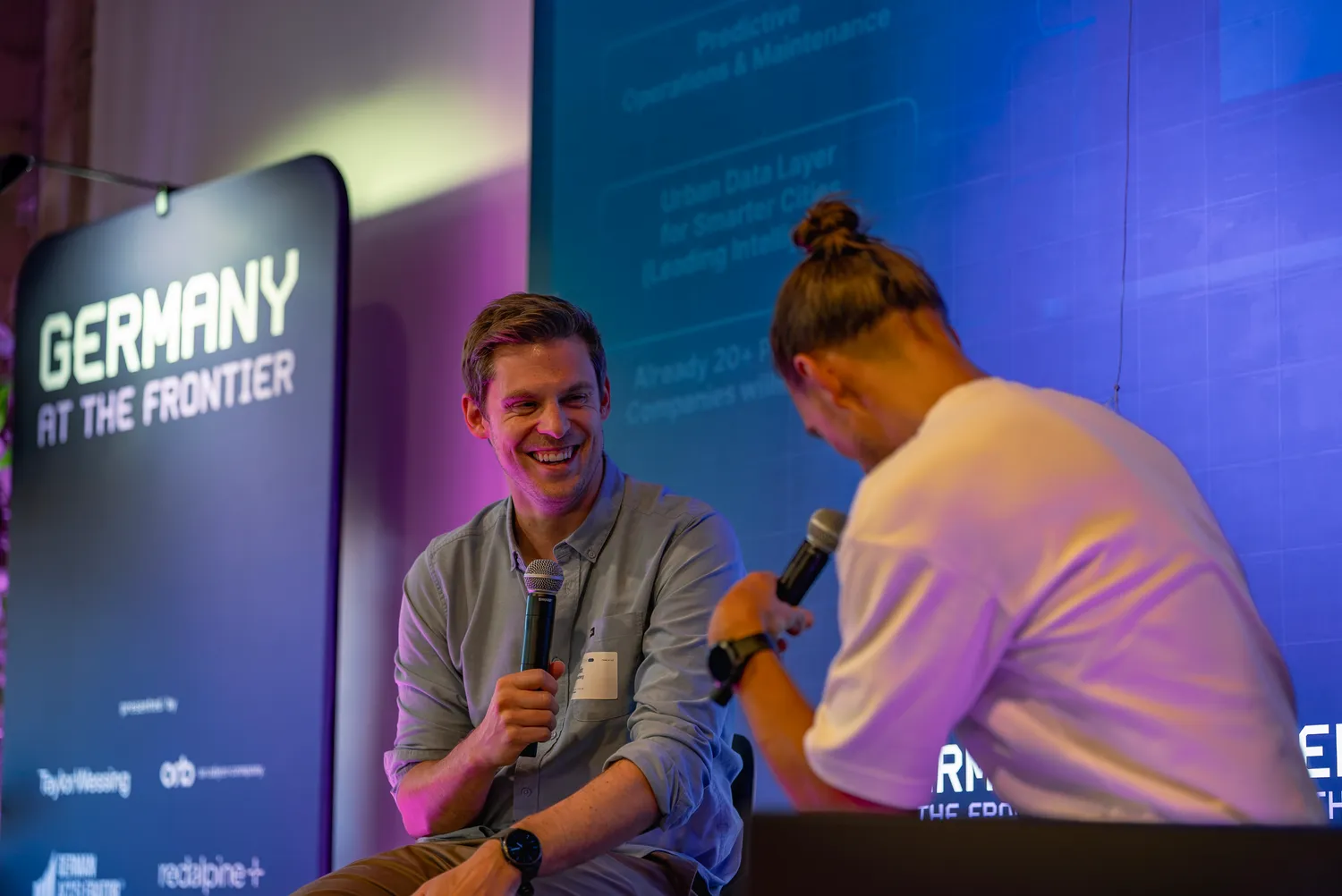 A speaker laughing during a fireside chat