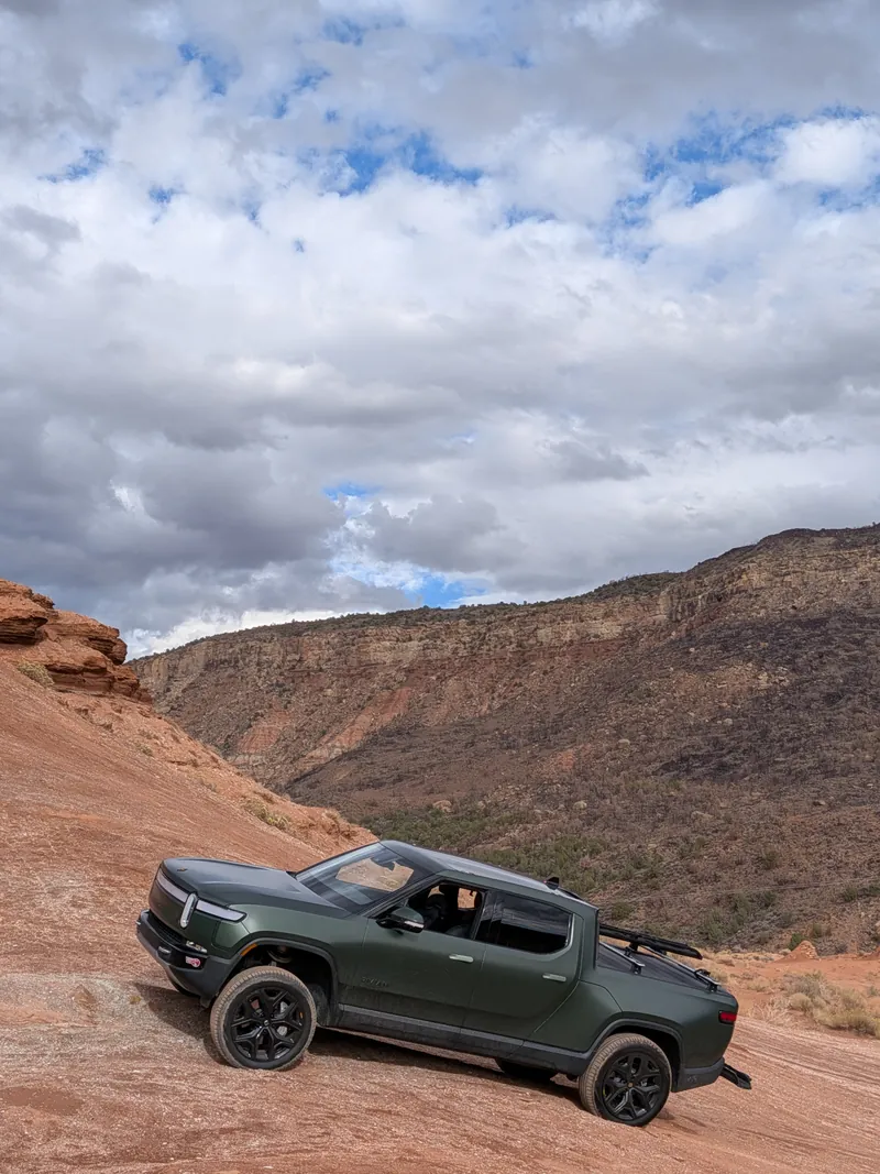 An electric pickup truck on a red-rock off-road trail